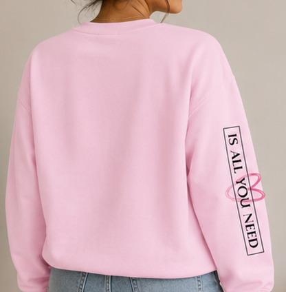 A four-panel collage showing a woman modeling a light pink crewneck sweatshirt from different angles. The sweatshirt features a pink heart outline with the word 'LOVE' in black script on the chest and 'I'D JUST KISS YOUR FACE' printed vertically on the sleeves.